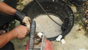 Houston commercial plumber working on large plugged drain in commercial building