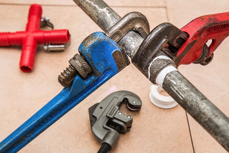 Plumbers wrenches around pipe for Houston commercial plumbing repair