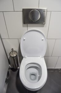 Toilet that needs replacement from Houston commercial plumber. 